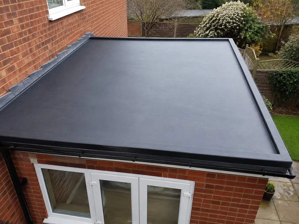A flat roof recovered over a sound deck, with the upstands and the outlet dressed in