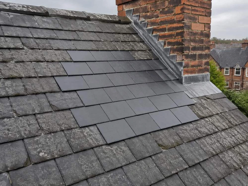 Slates replaced on a pitched roof, matched to the existing covering and fixed back into sound battens